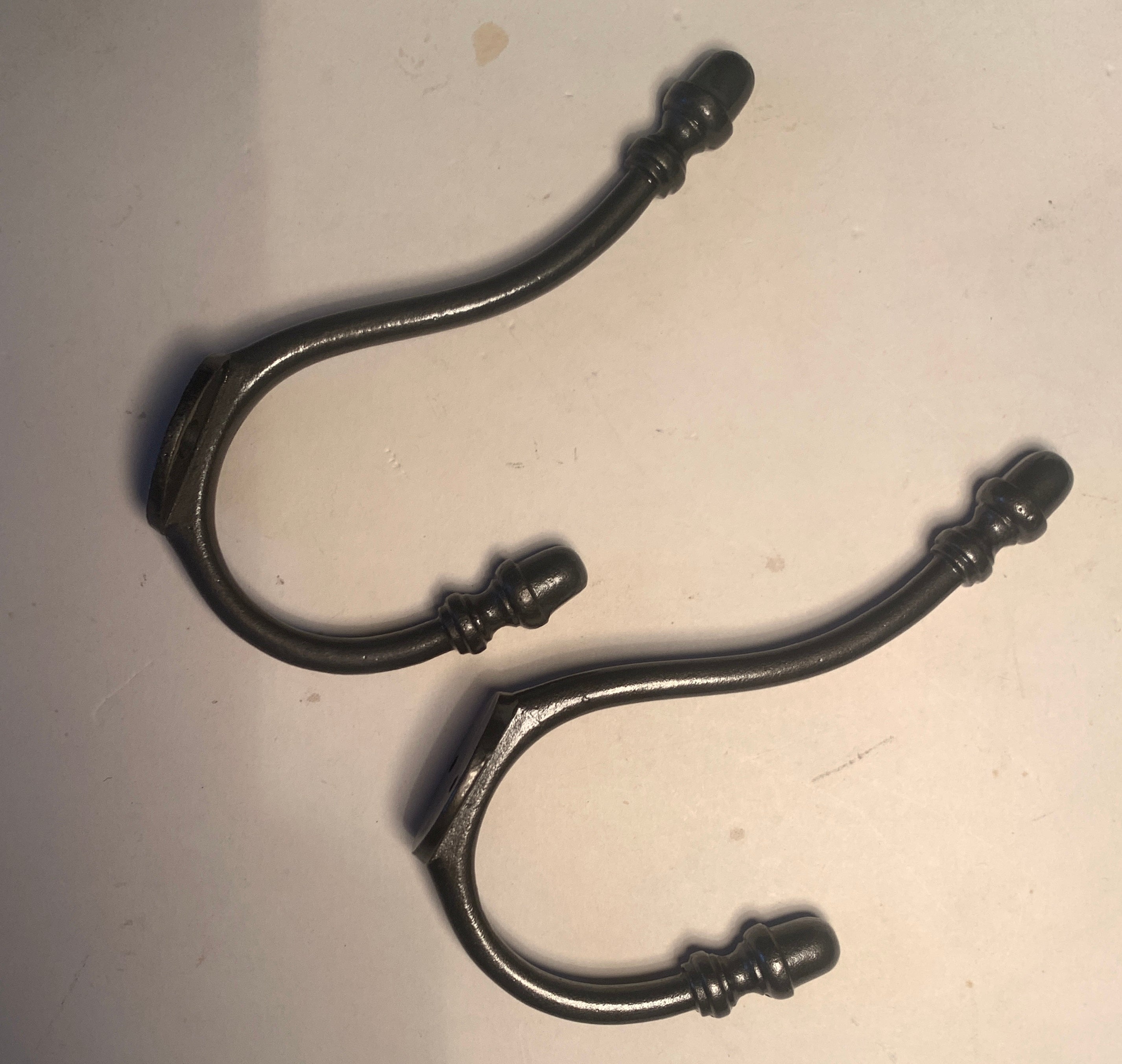 To clear: Pair of iron acorn hooks