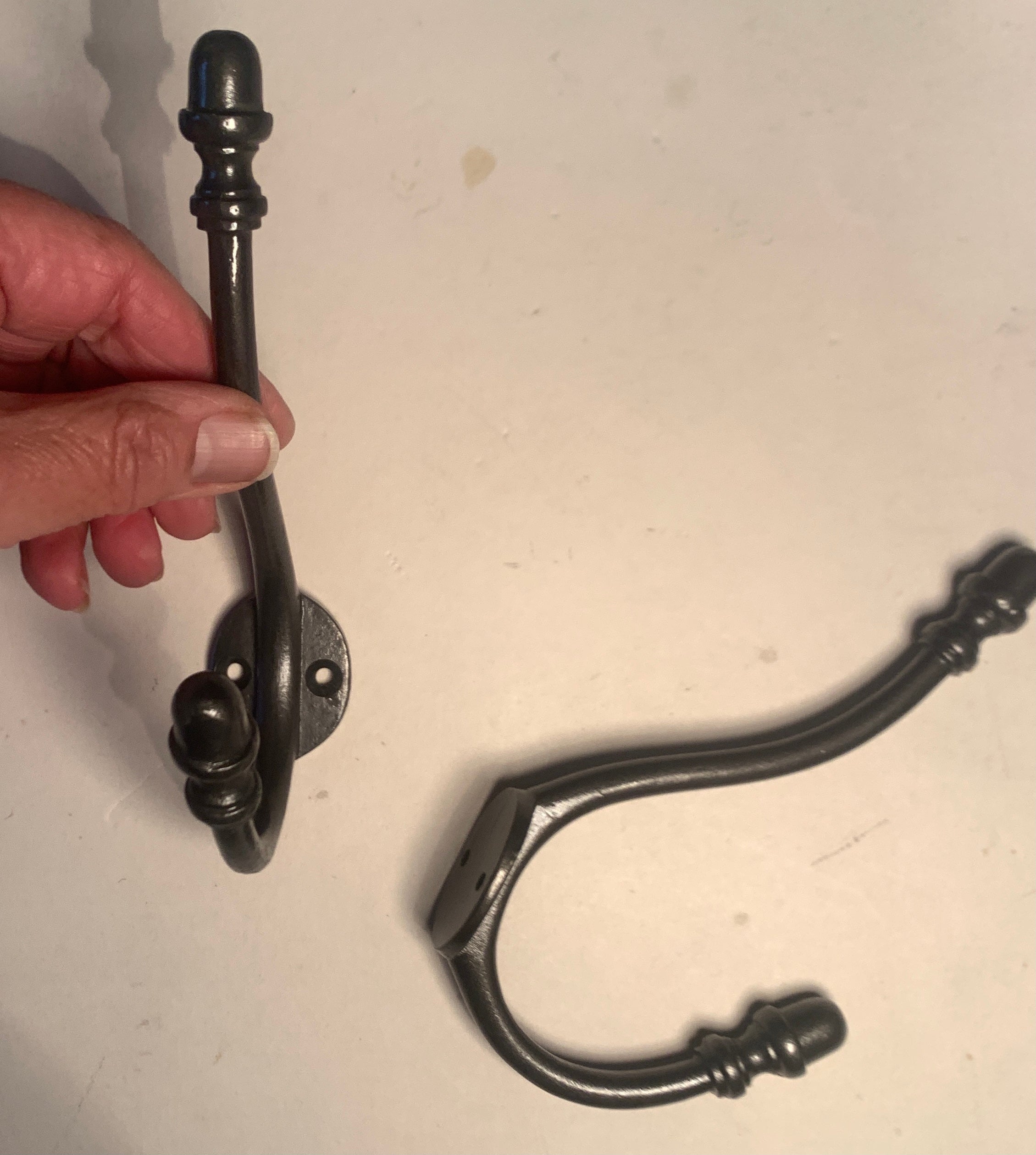 To clear: Pair of iron acorn hooks